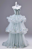 Light blue dress with floral details on a mannequin against a gray background