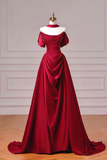 Red evening gown on a mannequin against a neutral background