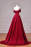 Red evening gown on a mannequin against a neutral background