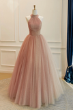 Pink evening gown on a mannequin against a neutral wall.
