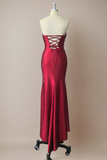 Red evening gown with lace-up back on a mannequin against a beige background