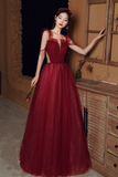 Woman in a red dress standing in a room with wooden furniture.