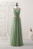 Green dress on a mannequin against a white wooden background