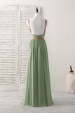 Green evening gown on a mannequin against a white background