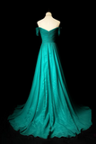 Teal evening gown on a mannequin against a black background