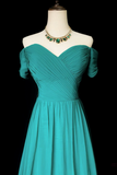 Teal off-shoulder dress on a mannequin with a necklace against a black background