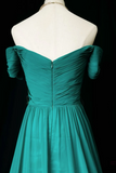 Teal off-shoulder dress on a mannequin against a black background