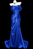 Blue evening gown on a mannequin against a black background
