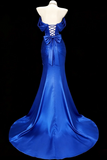 Blue evening gown on a mannequin against a black background