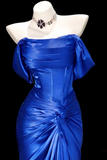 Blue evening gown on a mannequin with a black background