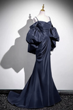 Navy blue evening gown on a mannequin against a white background
