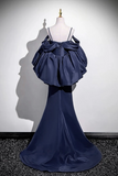 Navy blue evening gown on a mannequin against a white wall.