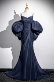 Navy blue evening gown with puff sleeves on a mannequin against a white background