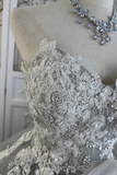 Close-up of intricate lace fabric on a mannequin with a necklace.