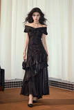 Woman wearing a black off-shoulder dress in an indoor setting
