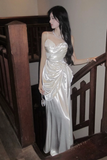 Woman in a silver dress standing on a staircase