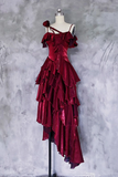 Red ruffled dress on a mannequin against a textured gray background