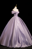 Purple ball gown on a mannequin against a black background
