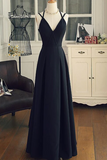 Navy blue evening gown on a mannequin in a room with furniture and decor.