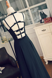 Navy blue evening gown with cut-out back on a mannequin against a neutral background.