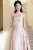 Woman in a pink evening gown standing on a staircase