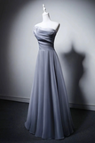 Gray evening gown on a mannequin against a gray background