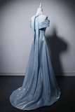 Blue evening gown on a mannequin against a gray background