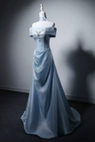 Blue evening gown on a mannequin against a gray background