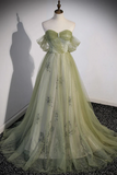 Green evening gown on a mannequin against a white wall