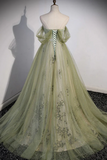Green evening gown on a mannequin against a white wall