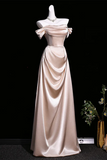 Elegant satin evening gown on a mannequin against a black background