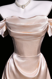 Beige satin evening gown on a mannequin with a black background