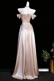 Beige evening gown on a mannequin against a black background
