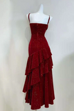 Red evening gown on a mannequin against a white background