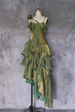 Green and gold dress on a mannequin against a gray textured wall