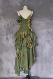 Green and gold ruffled dress on a mannequin against a textured gray background