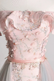 Close-up of a pink floral dress with a white background