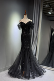 Black sequin evening gown on a mannequin against a gray wall.