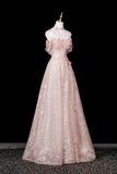 Pink evening gown on a mannequin against a black background