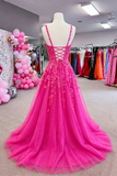 Pink evening gown on a mannequin in a store setting with balloons and other dresses.