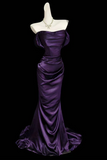 Purple evening gown on a mannequin against a black background