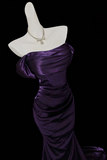 Purple evening gown on a mannequin with a black background