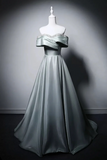 Mint green evening gown on a mannequin against a gray background