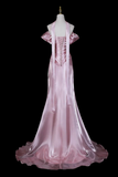 Pink evening gown on a mannequin against a black background