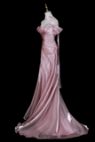 Pink evening gown on a mannequin against a white background