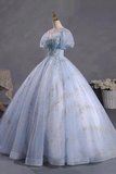Elegant light blue gown on a mannequin against a gray background