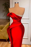 Red one-shoulder dress on a mannequin with a blurred indoor background