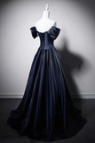 Navy blue evening gown on a mannequin against a gray background