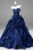 Navy blue ball gown on a mannequin against a gray background
