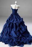 Navy blue ball gown on a mannequin against a gray background